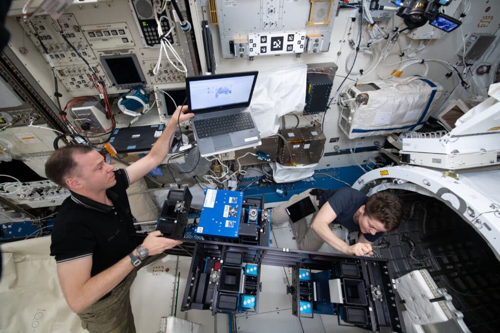 NASA astronauts Nick Hague and Anne McClain install the MISSE-FF