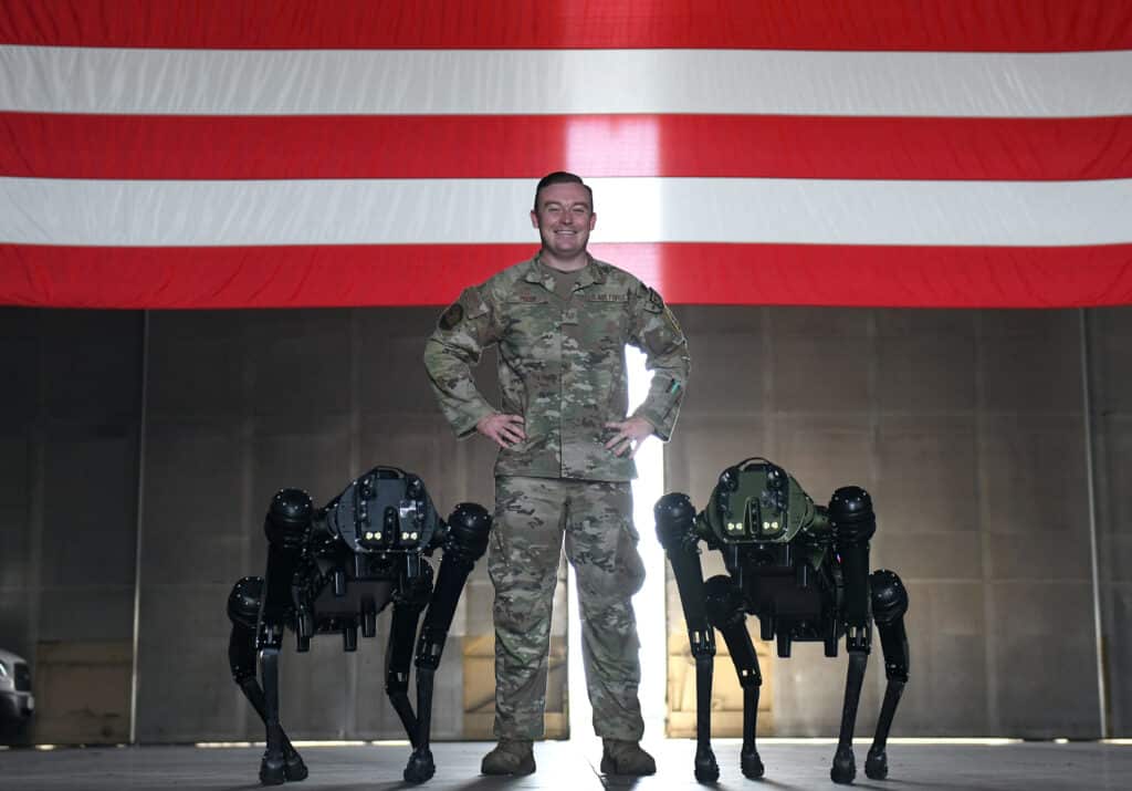 U.S. Air Force Tech Sgt. Brandon Priddy with dog-like Space Force robots