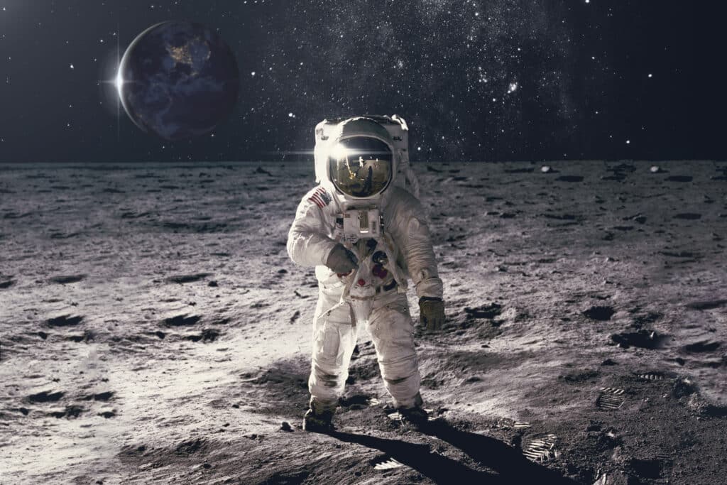 Astronaut on Moon or rock surface with space background. Elements of this image furnished by NASA