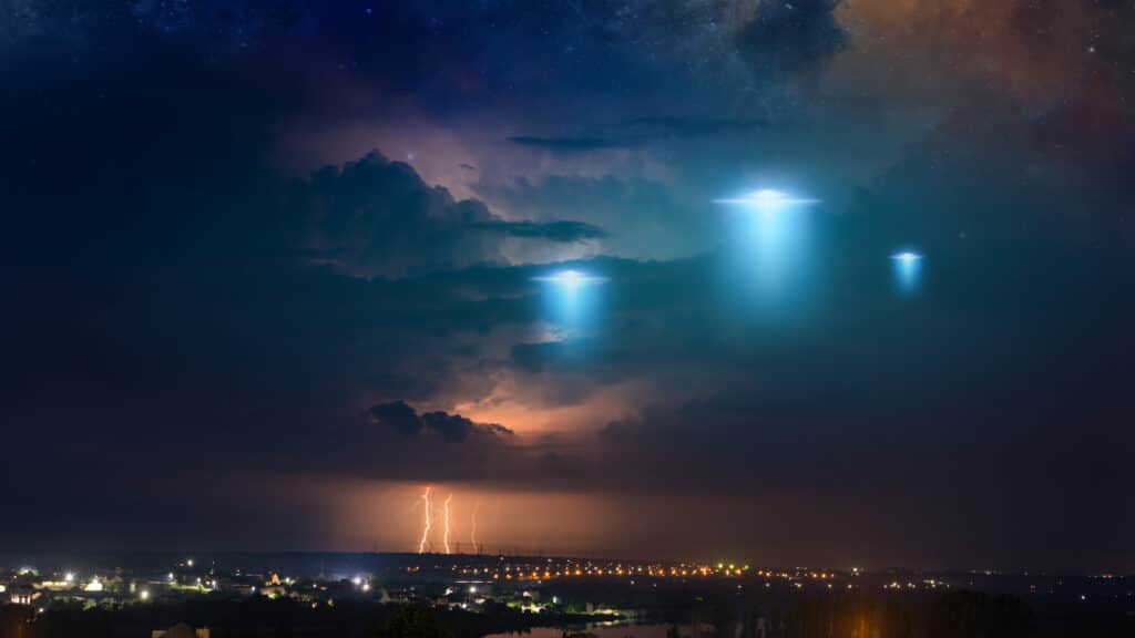 UFOs in night sky over city