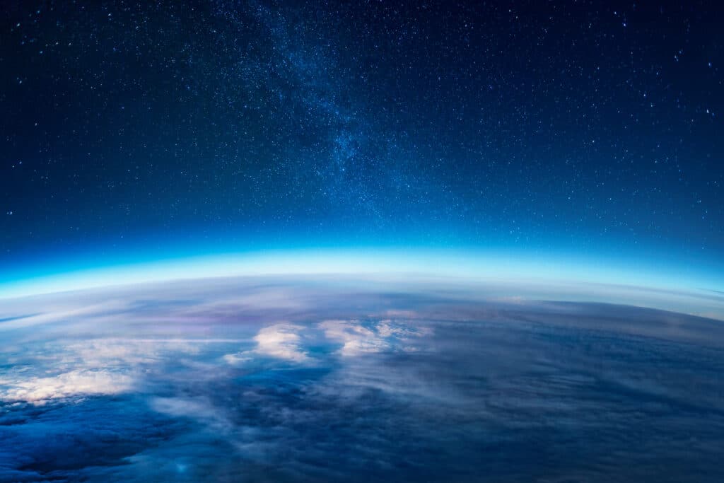 View of stars and Earth's atmosphere and stratosphere from space