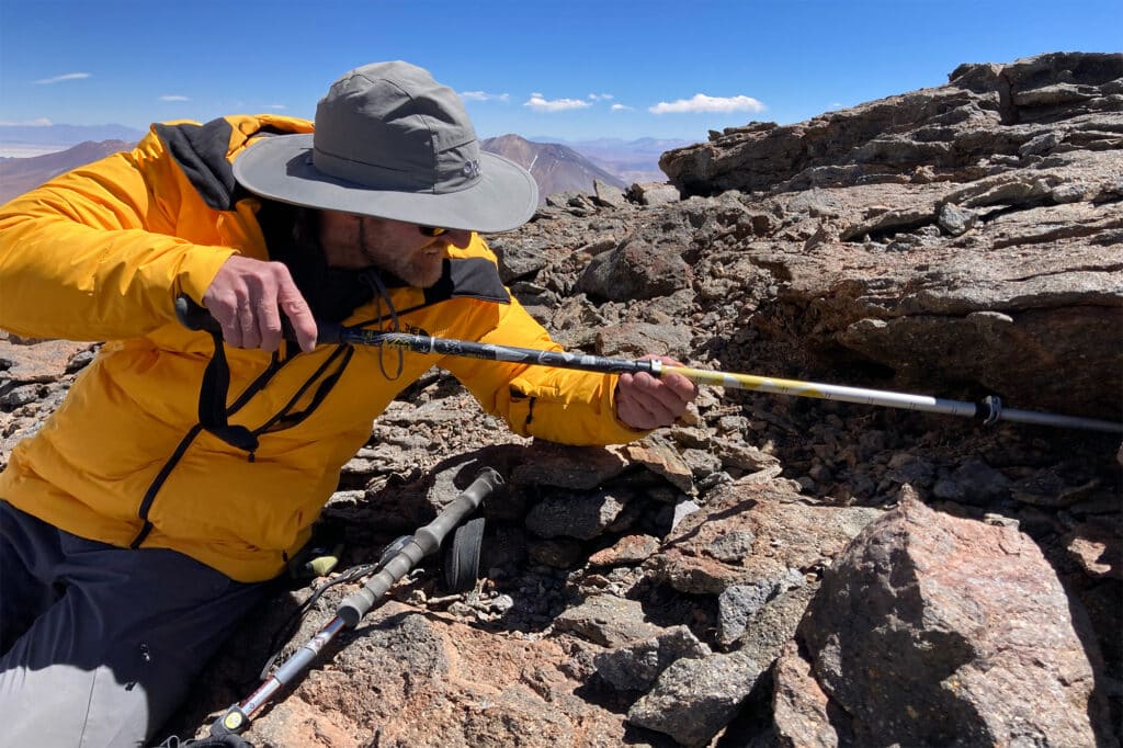 Jay Storz, a professor of biological sciences at the University of Nebraska–Lincoln, works to excavate a mouse mummy on the summit of an Andean volcano.
