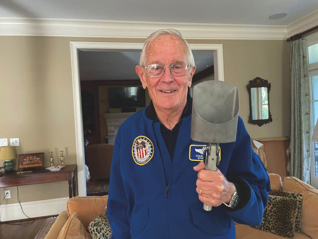Lunar Module Pilot Charlie Duke with the lunar soil scoop that played a pivotal role in NASA's Apollo 16 mission