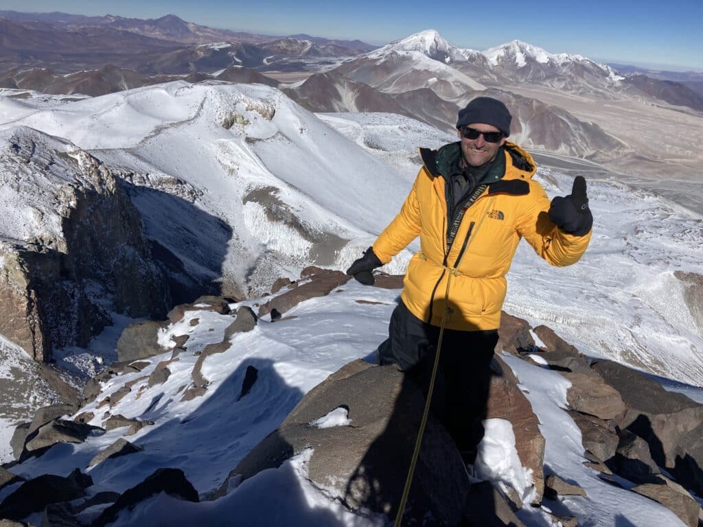 This photograph shows a member of the research team at the summit of Ojos del Salado.