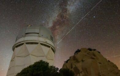 Trails in the night sky left by BlueWalker 3 are juxtaposed against the Nicholas U. Mayall 4-meter Telescope at Kitt Peak National Observatory in Arizona.