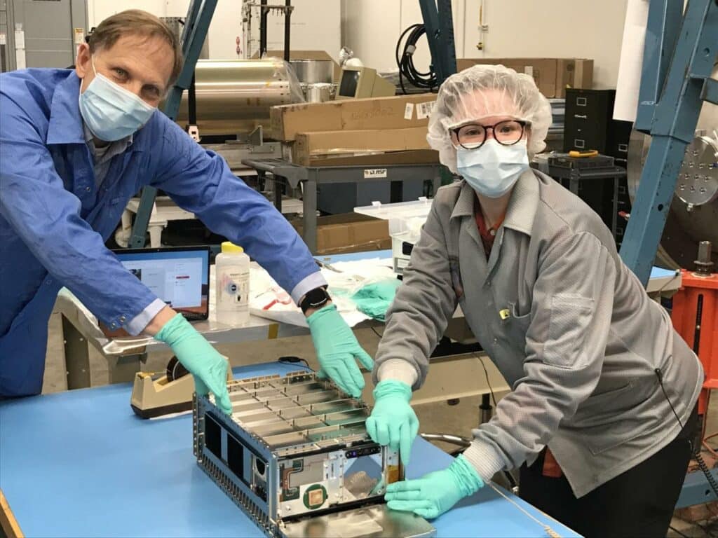 Rick Kohnert, systems engineer for CUTE, and former LASP graduate student Arika Egan pose with the small satellite on the CU Boulder campus.
