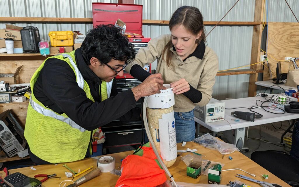 PhD candidate Ajay Gill from the University of Toronto (left) and Dr Ellen Sirks from the University of Sydney (right) working on a Data Recovery System package.