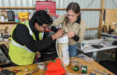 PhD candidate Ajay Gill from the University of Toronto (left) and Dr Ellen Sirks from the University of Sydney (right) working on a Data Recovery System package.