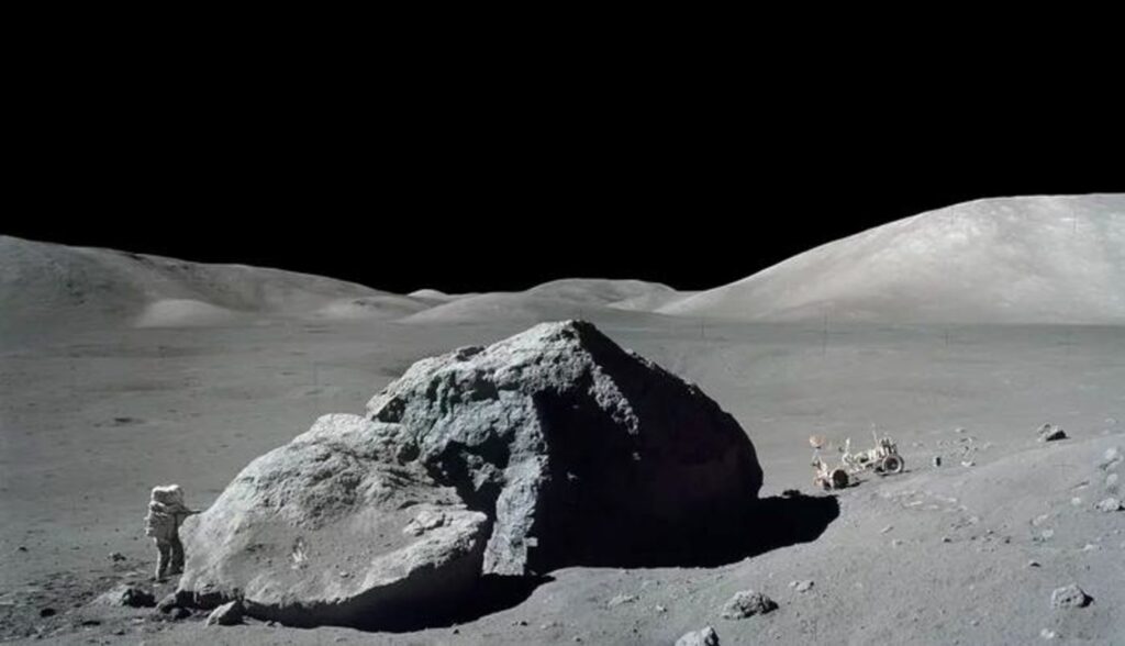 Image shows astronaut-geologist standing next to a huge lunar boulder during NASA’s Apollo 17 mission in 1972