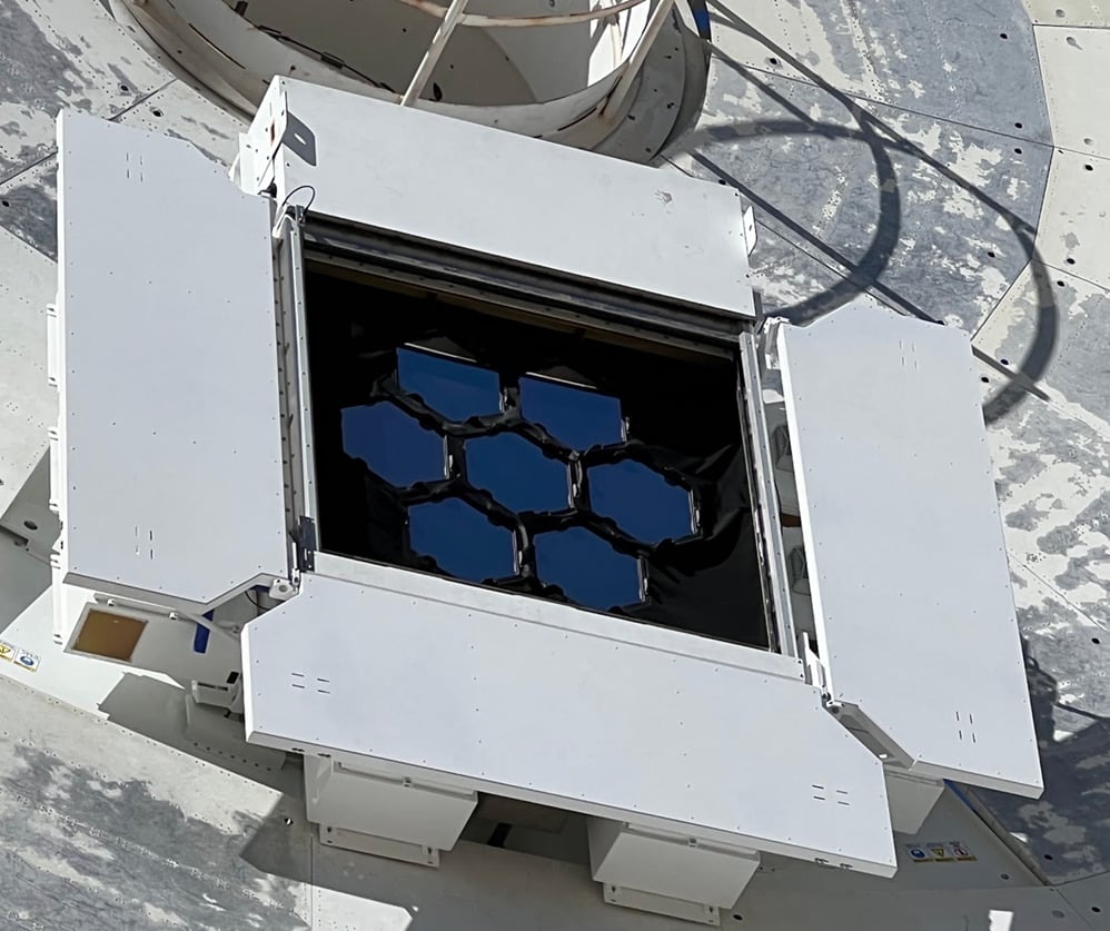 A close-up of the optical terminal on Deep Space Station 13 shows seven hexagonal mirrors that collect signals from DSOC’s downlink laser