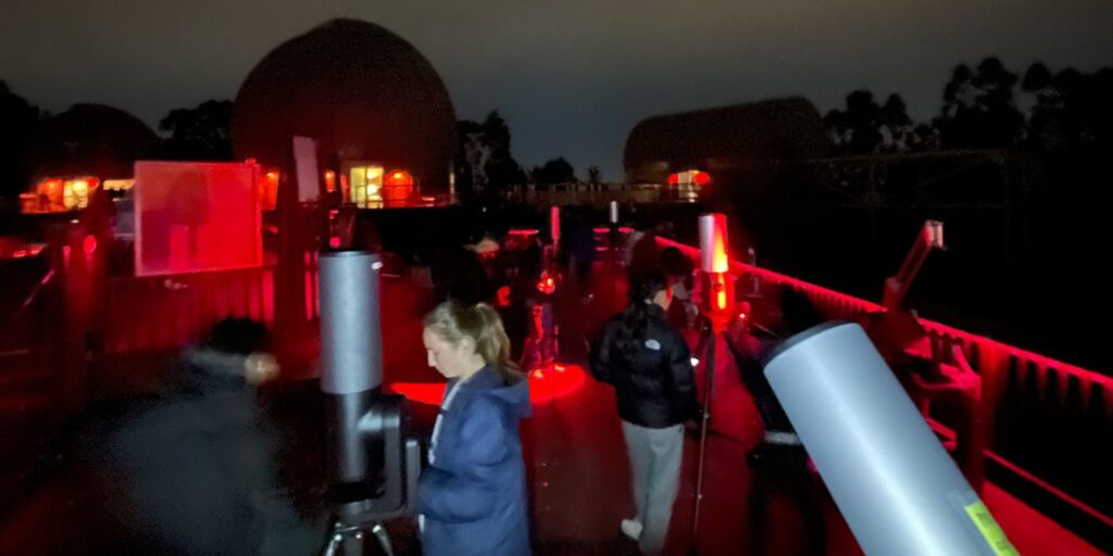 Students set up telescopes on the observation deck of Chabot Space & Science Center