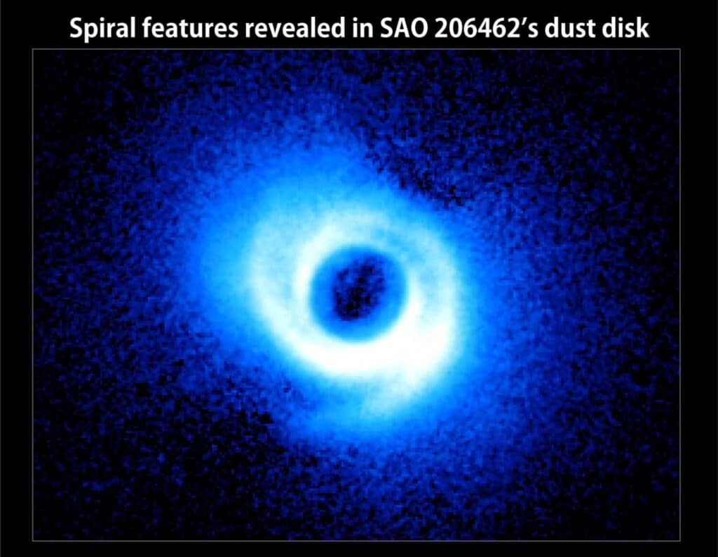 Two spiral arms emerge from the gas-rich disk around SAO 206462, a young star in the constellation Lupus
